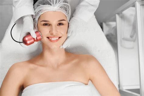 Satisfied Attractive Woman In Beautician On Procedure Stock Image