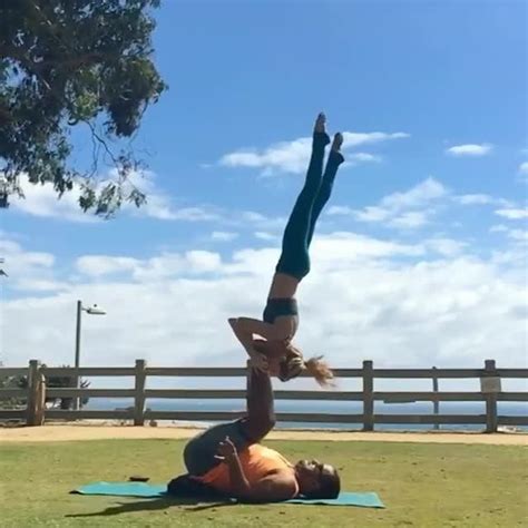 Couple Performs Acro Yoga Along Beachfront Jukin Licensing