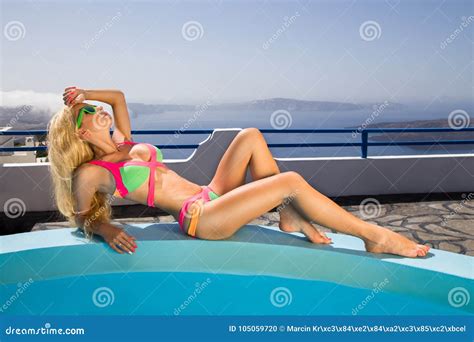 Beautiful Female Blonde Model With A Perfect Body And Amazing Long Hair On The Island Of