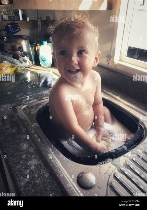 Baby Boy Having A Bath In The Sink Stock Photo Alamy