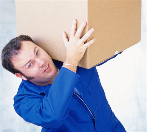 Man lifting a large box over his shoulder | Spyder Moving Services