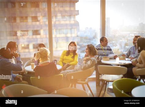 Business People Talking And Eating Lunch In Highrise Cafeteria Stock