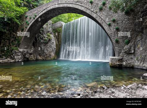 Traditional Stone Bridge And Waterfall Near Paleokaria Village In