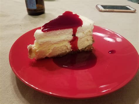 homemade ny cheesecake  sour cream topping  blackberry sauce food
