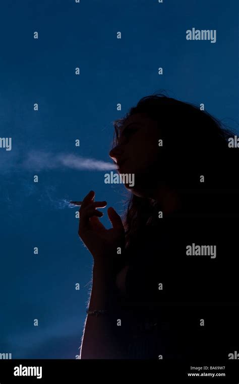 Woman Smoking Outside At Night Stock Photo Alamy