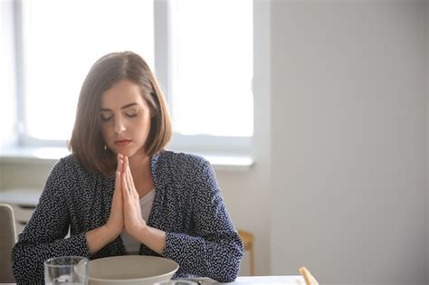 Premium Photo Young Woman Praying Before Meal At Home