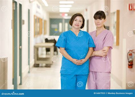 Two Female Nurses Standing In A Hospital Corridor Stock Image Image