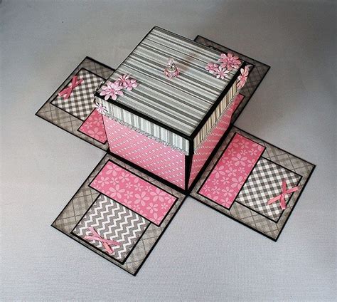 Three Boxes Are Stacked On Top Of Each Other With Pink And Gray Designs