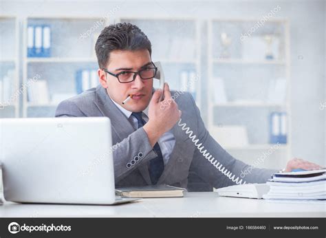 Businessman Smoking In Office At Work — Stock Photo © Elnur 166584460