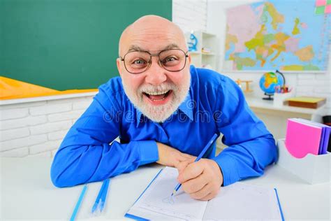 Happy Teacher With Microscope Near Chalkboard Pointing At Copy Space