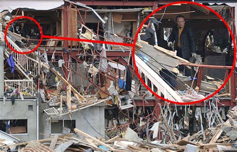 Japan Earthquake And Tsunami Man Sifts Through Office Wreckage In