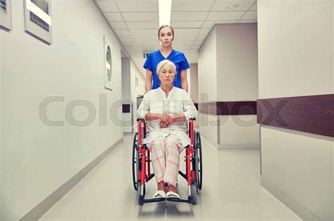 Nurse With Senior Woman In Wheelchair At Hospital Stock Image Colourbox