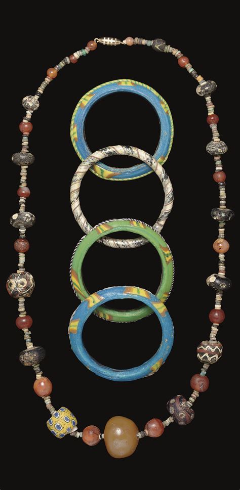 An Ancient Glass Bead Necklace And Four Ancient Glass Bracelets Circa 1st 10th Century A D