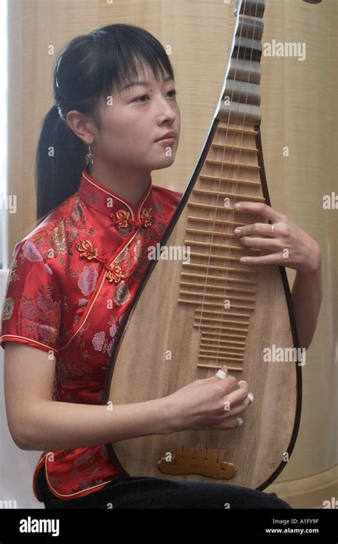 Chinese Woman Playing Traditional Chinese Lyre Type Musical Instrument