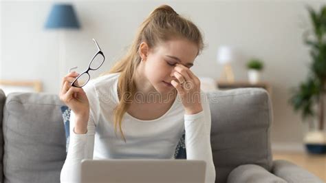 Woman Taking Off Glasses Suffering From Eyes Fatigue After Computer