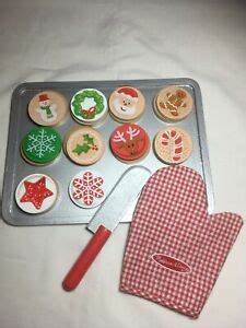 The melissa & doug, slice and bake wooden cookie play foot set includes 12 sliceable cookies, 12 toppings, knife, spatula, cookie sheet, and kitchen mitt; Melissa and Doug Christmas Cookies wooden play pretend food set Slice Bake | eBay