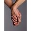 Couple Holding Hands With Fingers Entwined Together Stock Photo 