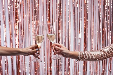 Premium Photo Close Up Of Two Female Hands Clinking Champagne Glasses