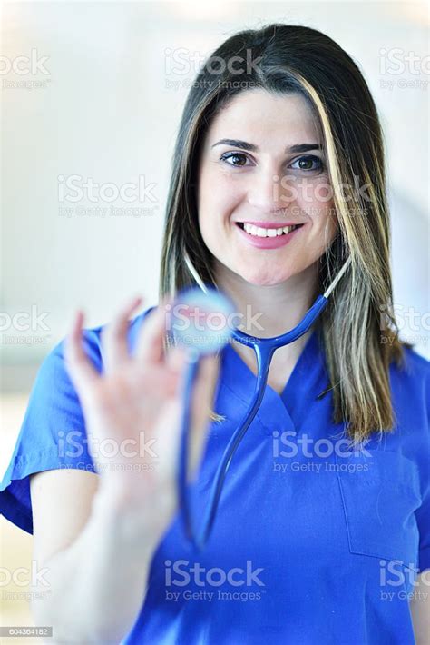 Portrait Of Woman Doctor At Hospital Corridor Looking At Camera Stock