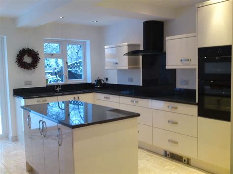 A white kitchen with black granite can work for a variety of design styles and provide excellent contrast and visual interest. homebase kitchens - Google Search | Black kitchens, White ...