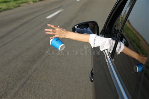 Driver Throwing Away Paper Cup From Car Window Garbage On Road Stock