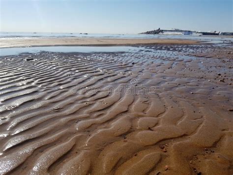 Charming Panoramic View Of The Bay Beach With Wavy Wet Sand Blue Sky