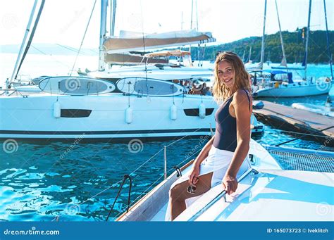 Happy Young Woman Feels Fun On The Luxury Sail Boat Yacht Catamaran In Turquoise Sea In Summer