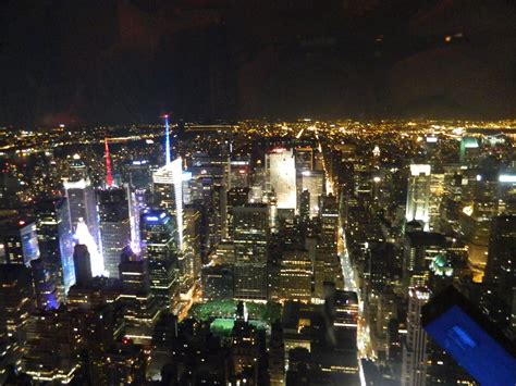 An Aerial View Of New York City At Night From The Top Of The Empire