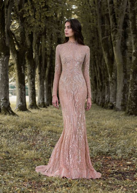 Featuring a dramatic lace train with light beading accenting the intricate lace applique. Rose gold gossamer wing-inspired long sleeved wedding ...