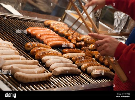 Bratwurst German Sausage Cooking On A Grill In A Christmas Market