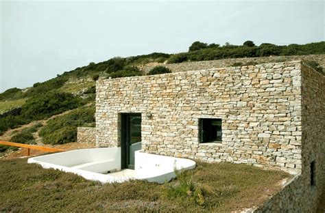 Stepped House With Stone Walls And Standout White Cube