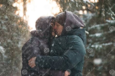 A Young Couple Kissing Under A Snowfall Stock Image Image Of