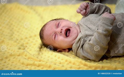 Newborn Baby Lying And Crying Suffering Abdominal Colic Emergence Of