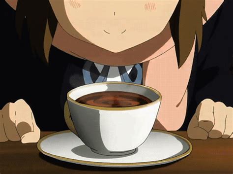 A Person Sitting At A Table With A Cup Of Coffee