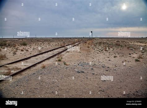 Abandoned Railroad Line In Desert Rusted Rails And Wooden Sleepers