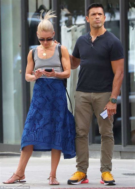 Kelly Ripa Receives A Kiss From Husband Mark Consuelos During Romantic Stroll Around New York