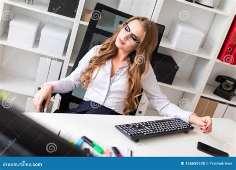 Beautiful Young Girl Sits In A Chair In The Office Stock Photo Image