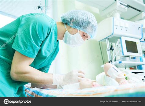 Neonatal Resuscitation Doctor Doing Intensive Therapy To Newborn Baby