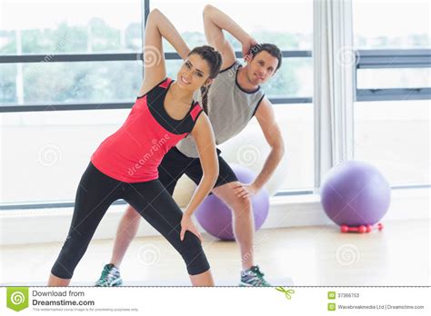 Two People Doing Power Fitness Exercise At Yoga Class