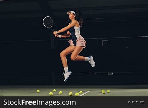 Female Tennis Player In A Jump On A Tennis Court Free Stock Images