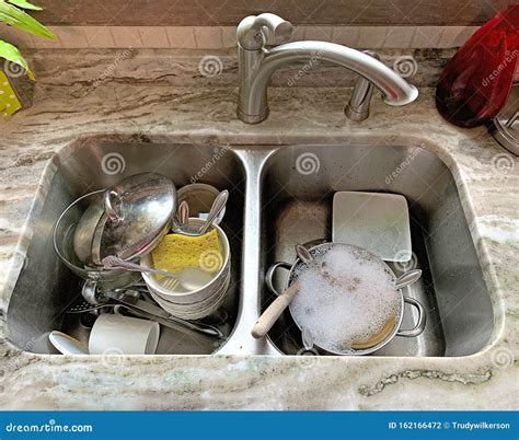 Kitchen Double Stainless Steel Sink Filled With Dirty Dishes Stock