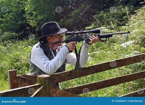 Man Leaning On A Wooden Gate With A Gun Stock Image Image Of Male