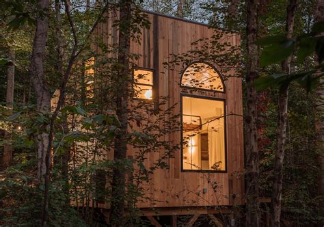 This Small House In The Forest Has High Ceilings To Allow For Two Loft