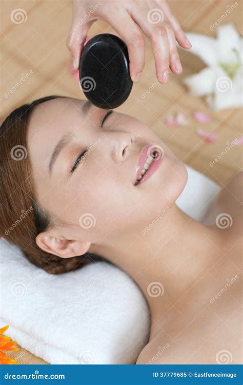 A Young Lady Enjoying Stone Massage At Spa Stock Image Image Of East