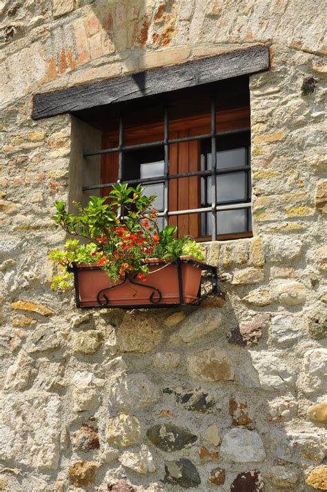 Window In A Stone Wall With Flowers Traditional Architecture Stock