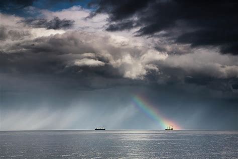 A Rainbow Through Storm Clouds Over An By John Short Design Pics