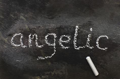 The Word Angelic Written With Chalk On Black Stone. Stock Photo  Image