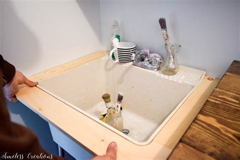 This old house has a great video showing how to add new plumbing, the only thing we'd change is the double wye fitting and use a double fixture fitting instead so the weir is below the vertical hub. DIY Utility Sink Makeover - Timeless Creations