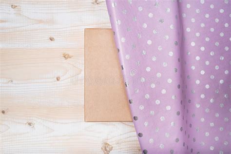 Cardboard Box And Lilac Polka Dot Wrapping Paper Wooden Table Stock