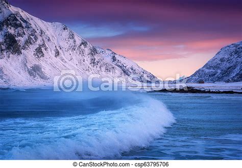 Sandy Beach With Blue Sea And Waves In Winter At Sunset In Lofoten